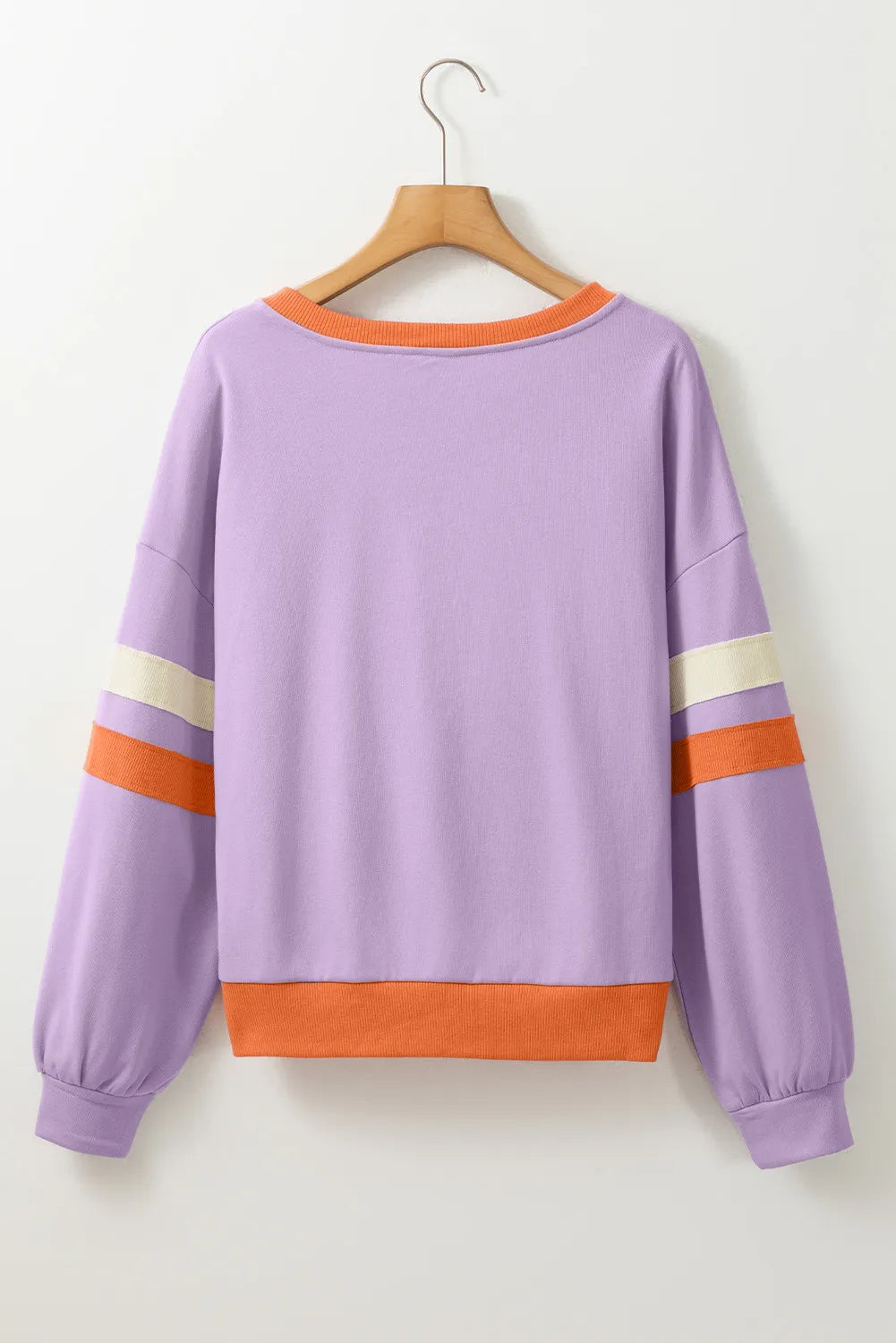 Woman wearing a lilac sweatshirt with a glittery orange checkered pumpkin and the phrase “Hello Pumpkin,” styled with denim shorts — cozy fall sweatshirt from A Whimsical Affair.
