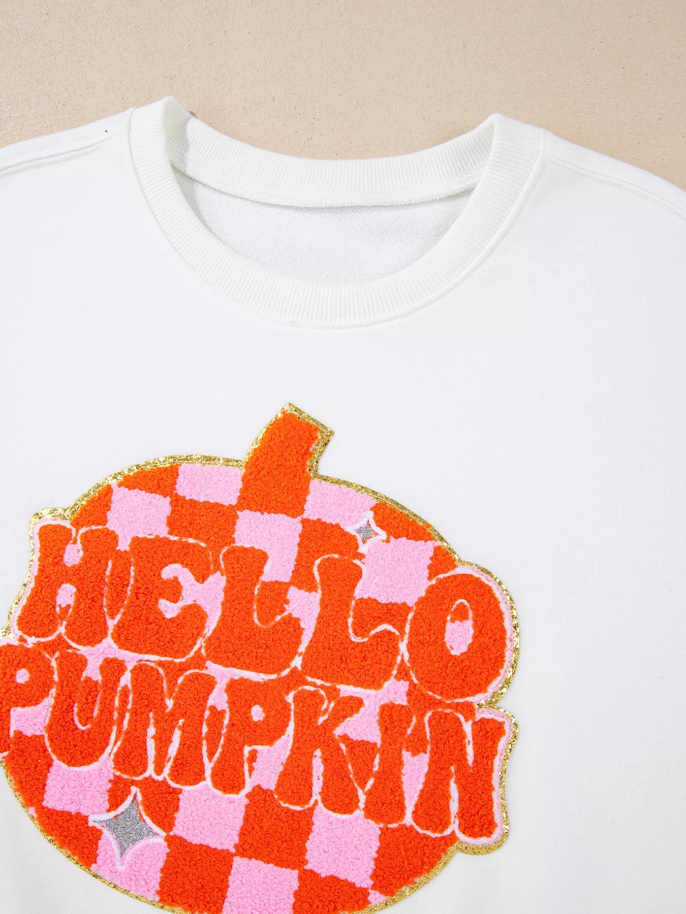 White sweatshirt with retro “Hello Pumpkin” lettering inside checkerboard pumpkin graphic – Retro Pumpkin style from A Whimsical Affair.