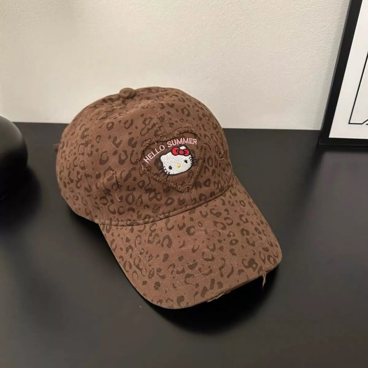 Brown leopard print cotton baseball cap with two-tone brim and embroidered Hello Summer kitty patch on the front.