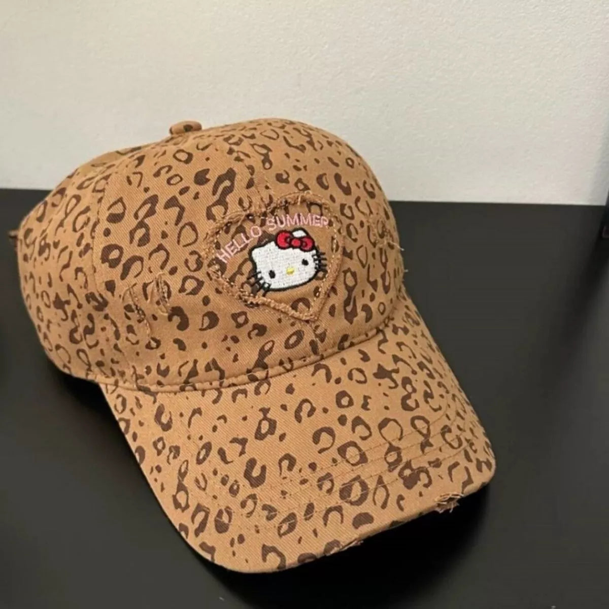 Brown leopard print cotton baseball cap with two-tone brim and embroidered Hello Summer kitty patch on the front.