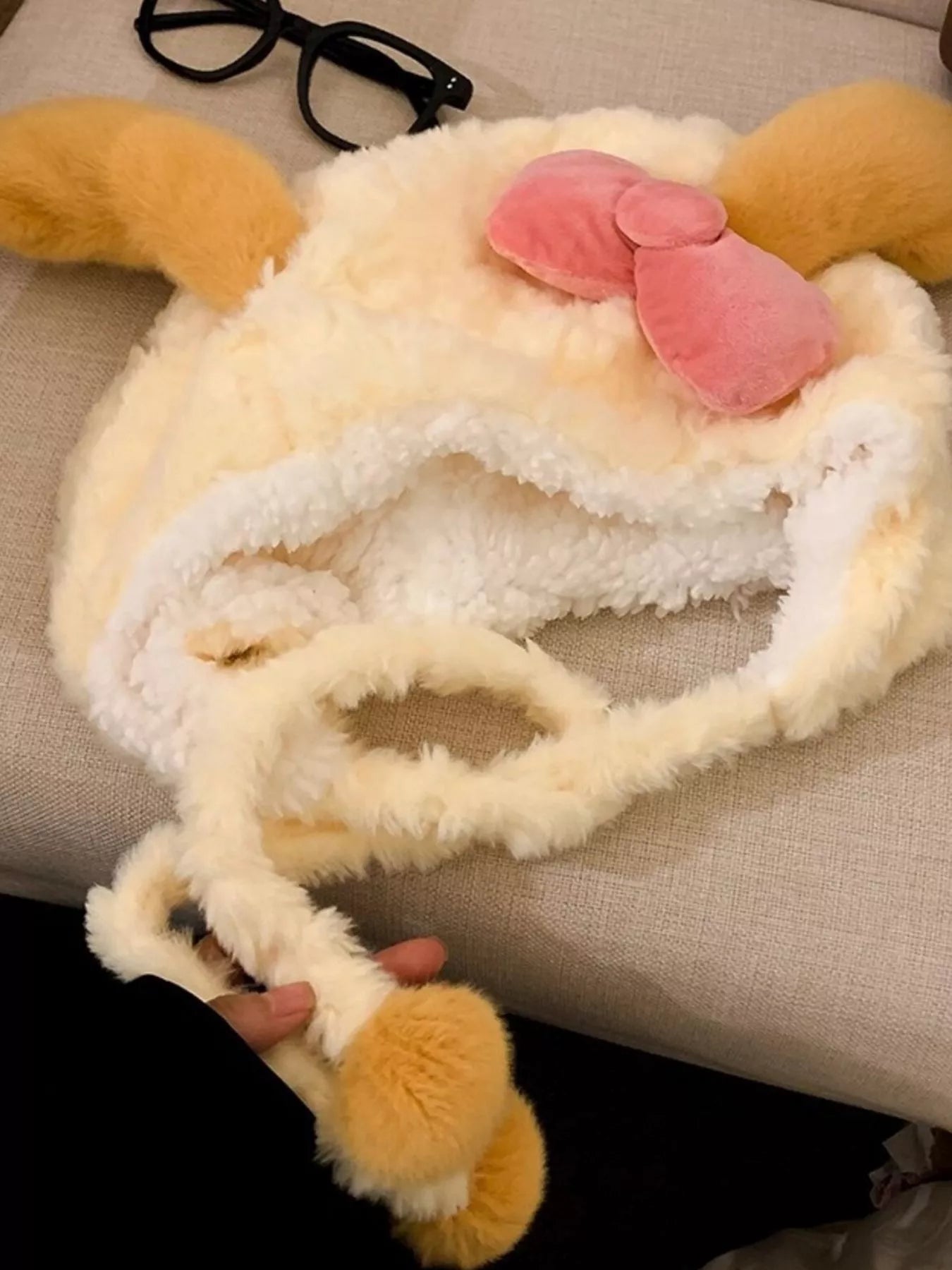 Soft plush earflap hood with floppy ears and pink velvet bow.