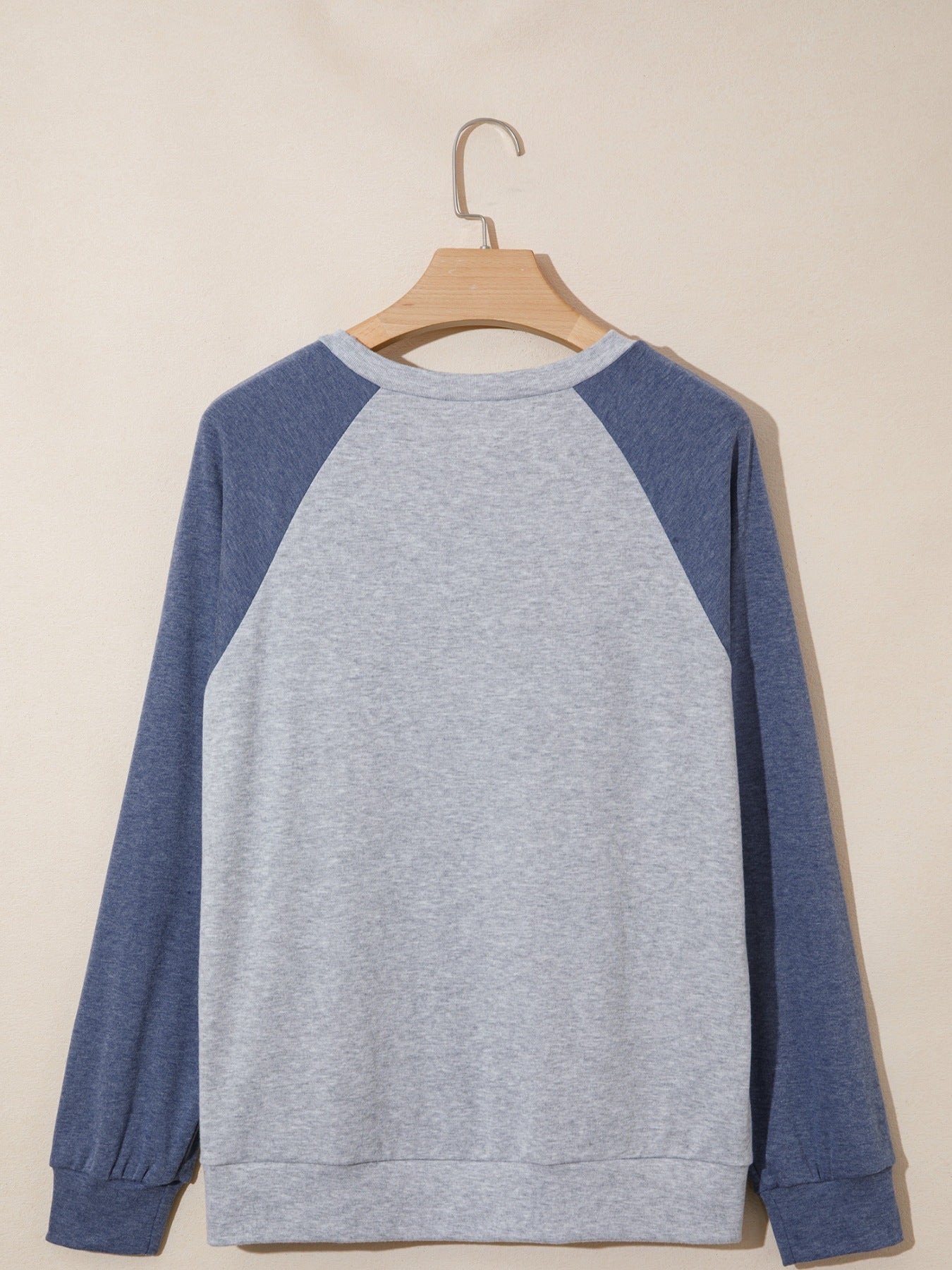 Gray raglan top with navy embroidered floral appliqué