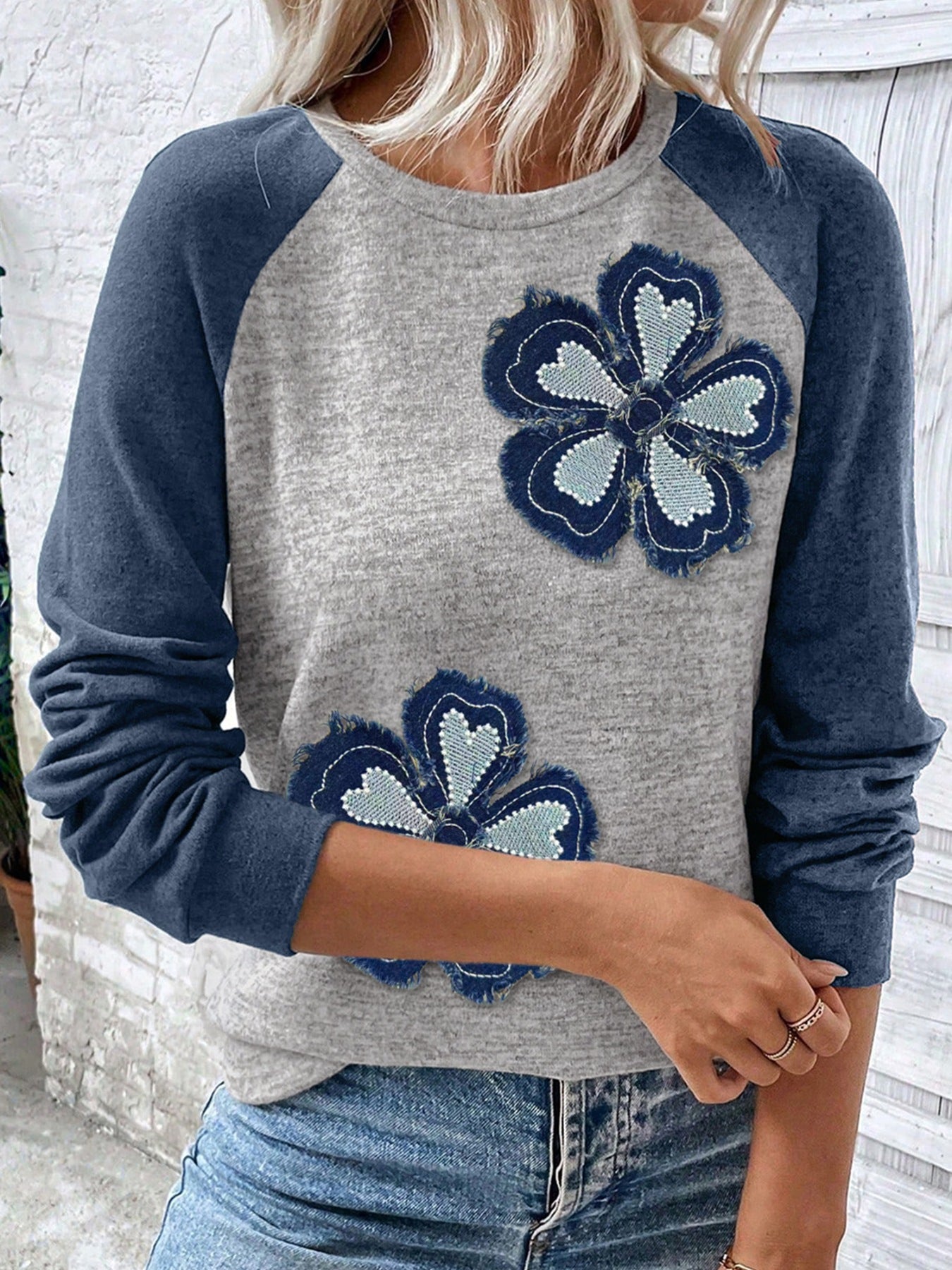 Gray raglan top with navy embroidered floral appliqué