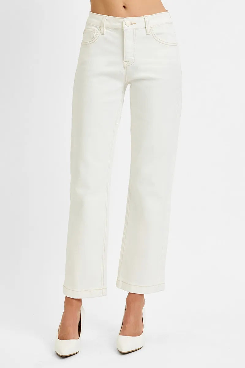 Woman wearing Ivory Edge Straight Jeans with mid rise tummy control and ankle length cut.