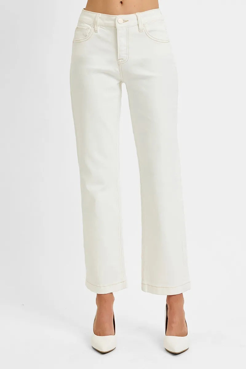 Woman wearing Ivory Edge Straight Jeans with mid rise tummy control and ankle length cut.