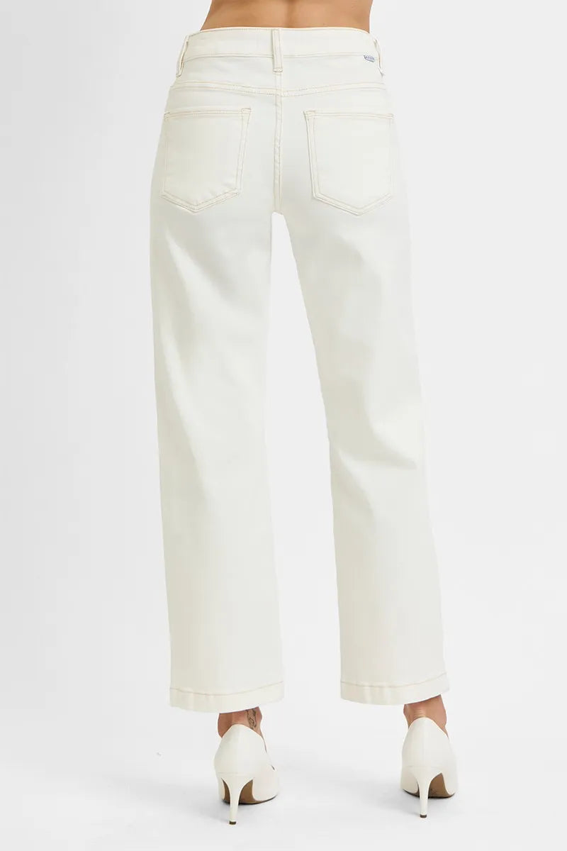 Woman wearing Ivory Edge Straight Jeans with mid rise tummy control and ankle length cut.