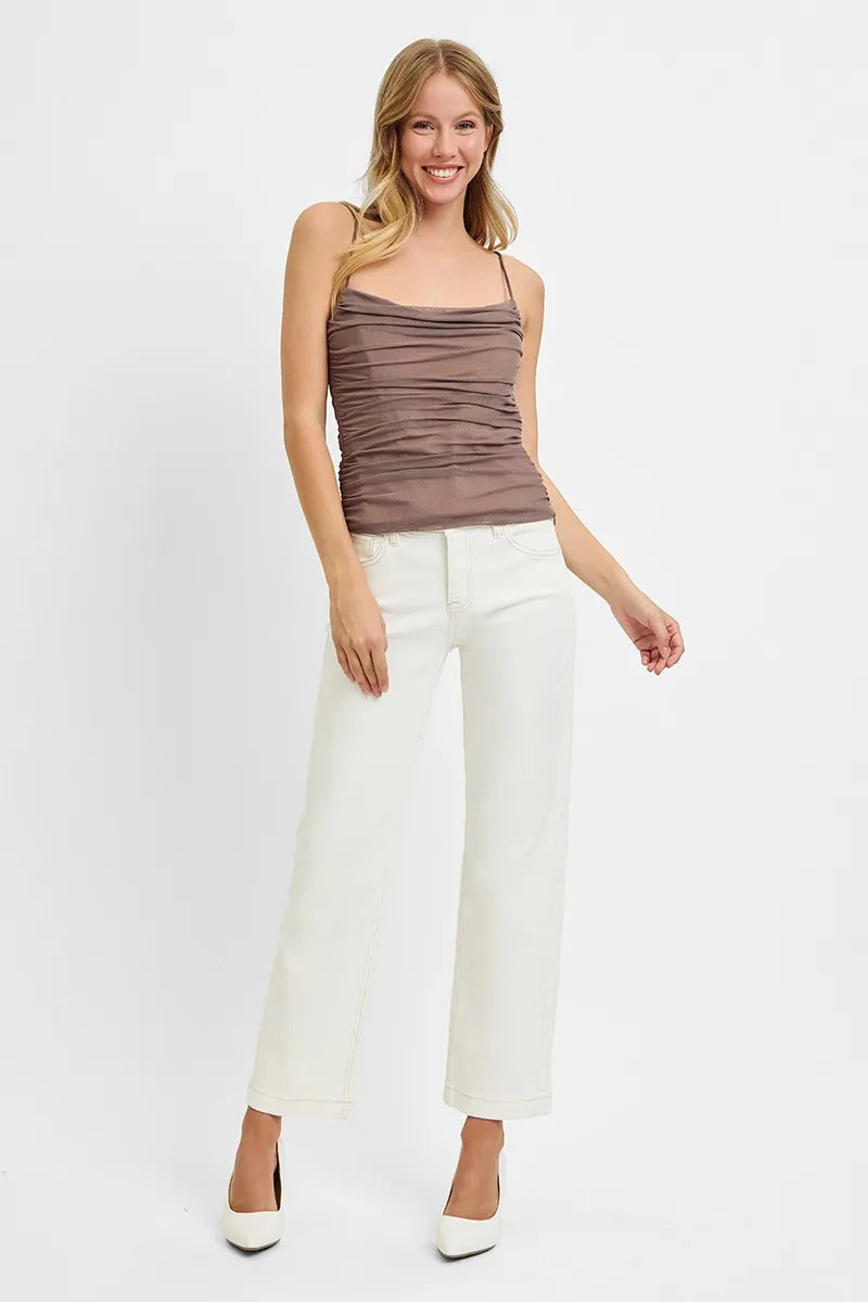 Woman wearing Ivory Edge Straight Jeans with mid rise tummy control and ankle length cut.