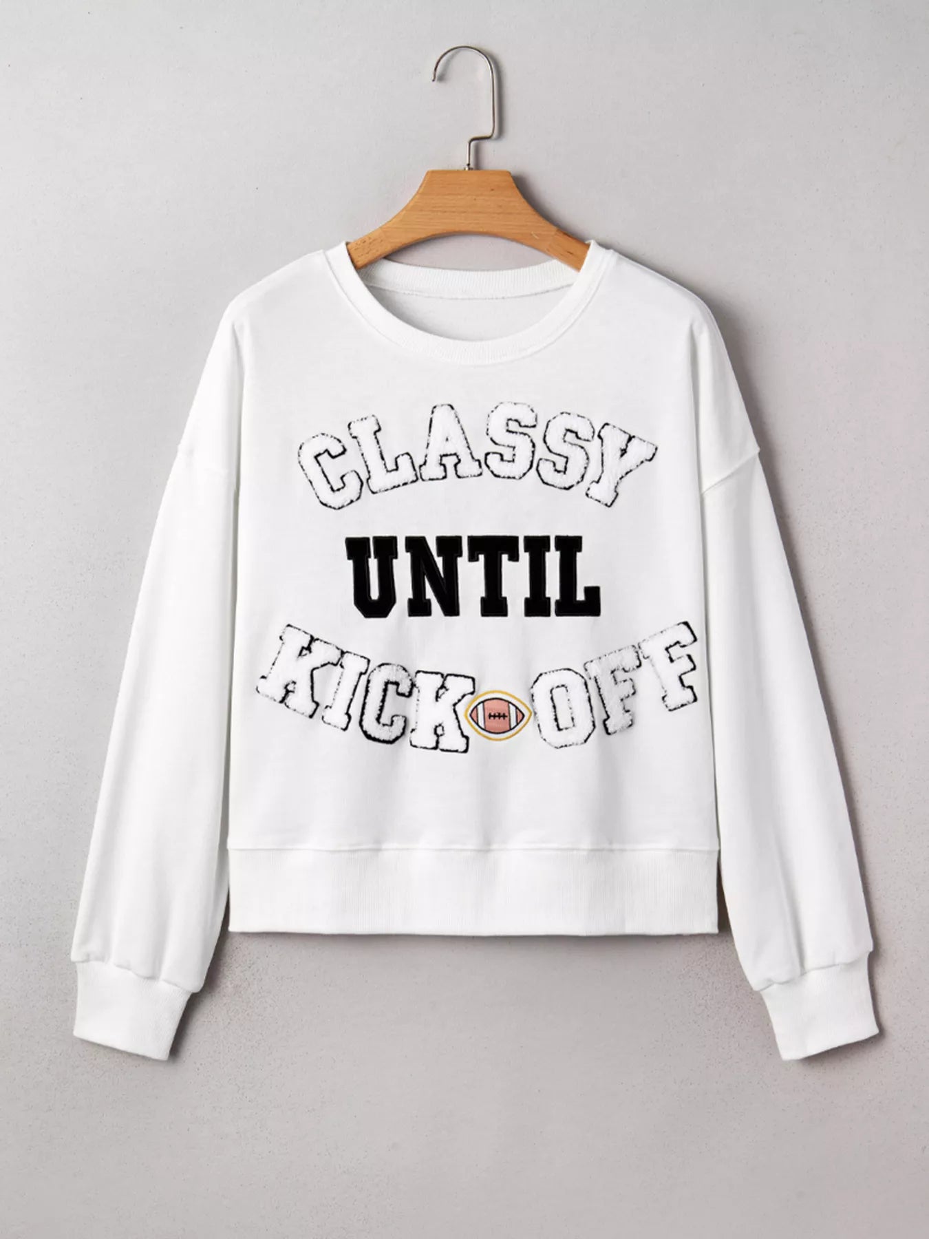 White Kickoff Queen sweatshirt with bold varsity lettering, cozy oversized fit, and casual sporty game day style.