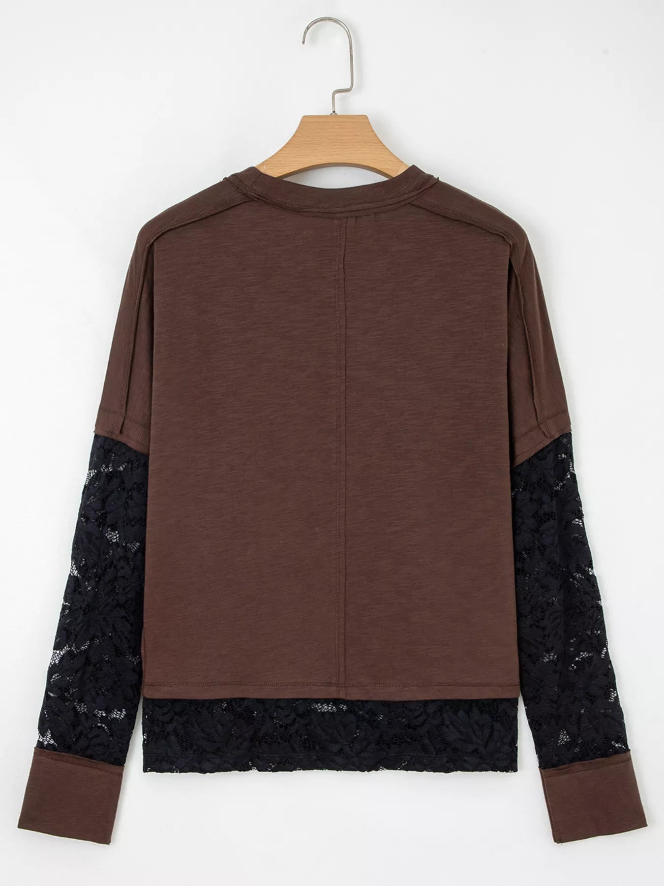 Woman wearing an oversized brown “Spooky” sequin graphic top with black lace sleeves and hem — layered Halloween tee from A Whimsical Affair.