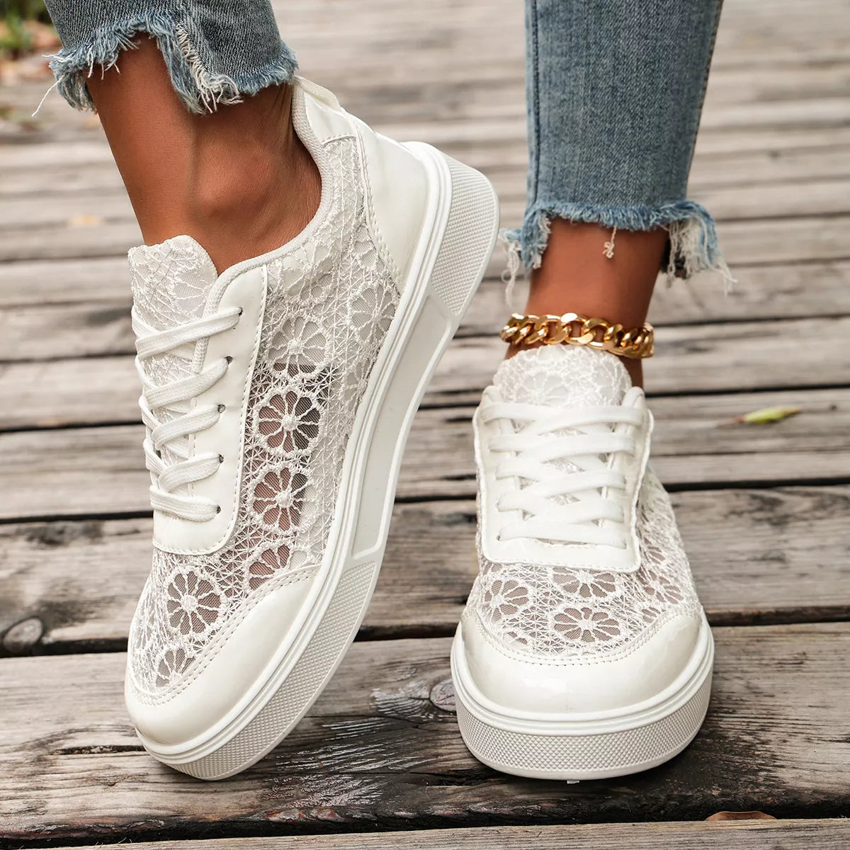 Floral lace mesh sneaker flats with lace-up design, flat heel, rubber sole, and casual everyday styling shown in black and white.