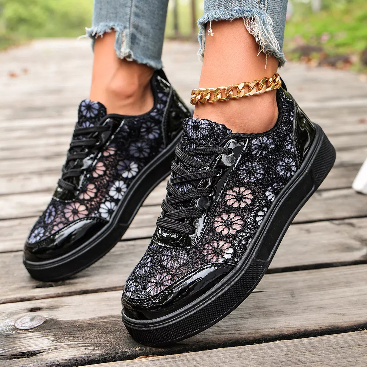 Floral lace mesh sneaker flats with lace-up design, flat heel, rubber sole, and casual everyday styling shown in black and white.