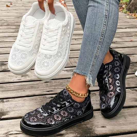 Floral lace mesh sneaker flats with lace-up design, flat heel, rubber sole, and casual everyday styling shown in black and white.