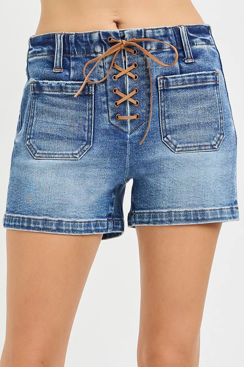 High-rise blue denim shorts with front lace-up tie detail, patch pockets, belt loops, and a cotton-blend fit.