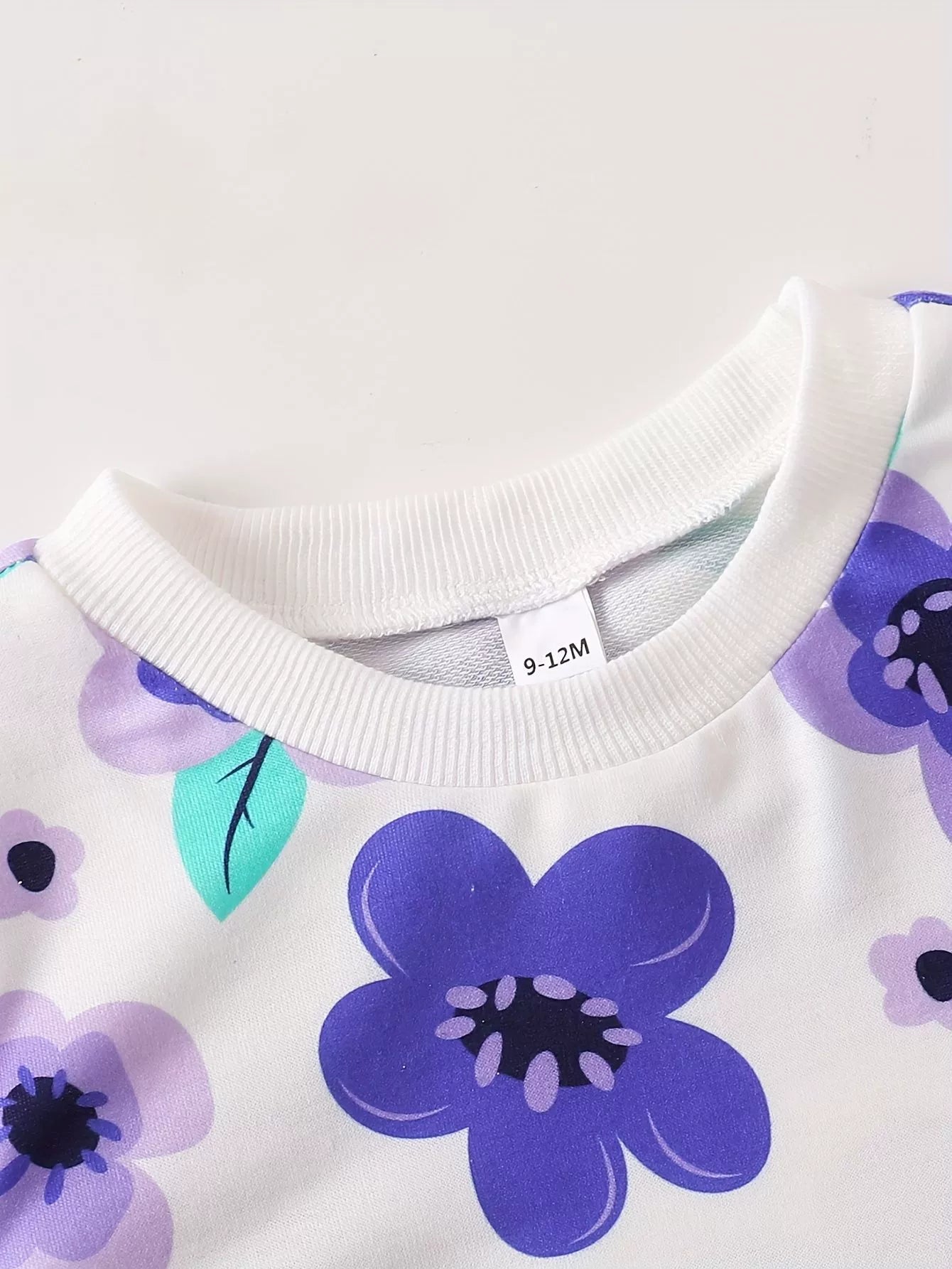 Children’s purple floral two-piece outfit with long sleeve top and leggings