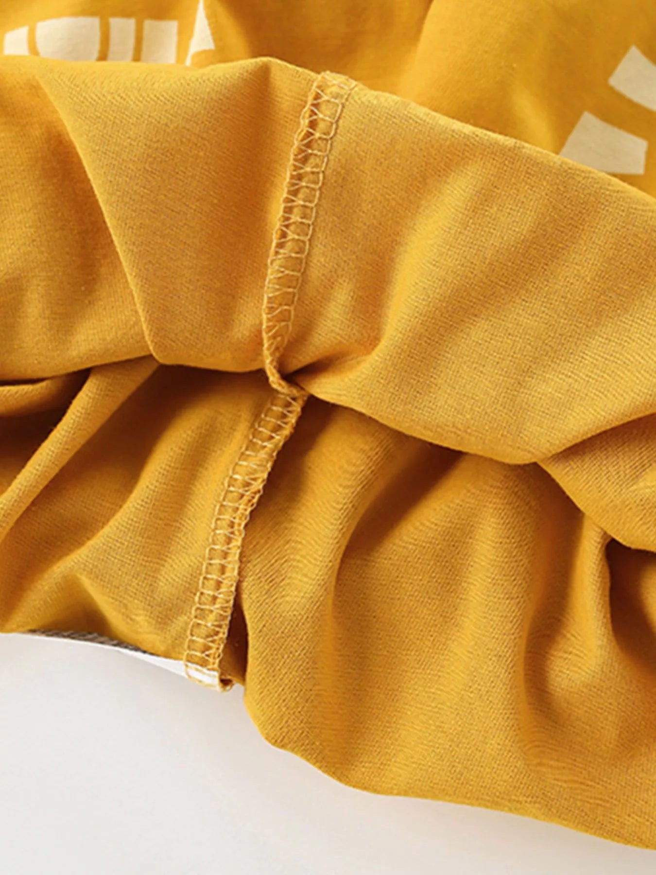 Mustard yellow kids two piece set with white sunshine print short sleeve top and matching shorts