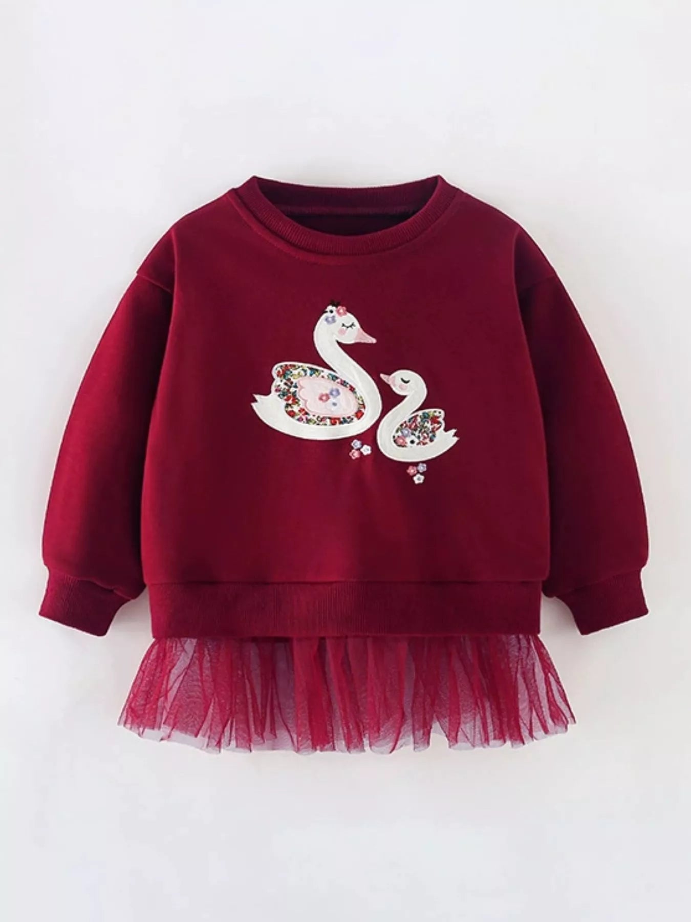 Girls long-sleeve sweatshirt with swan graphic and ruffled tulle hem.