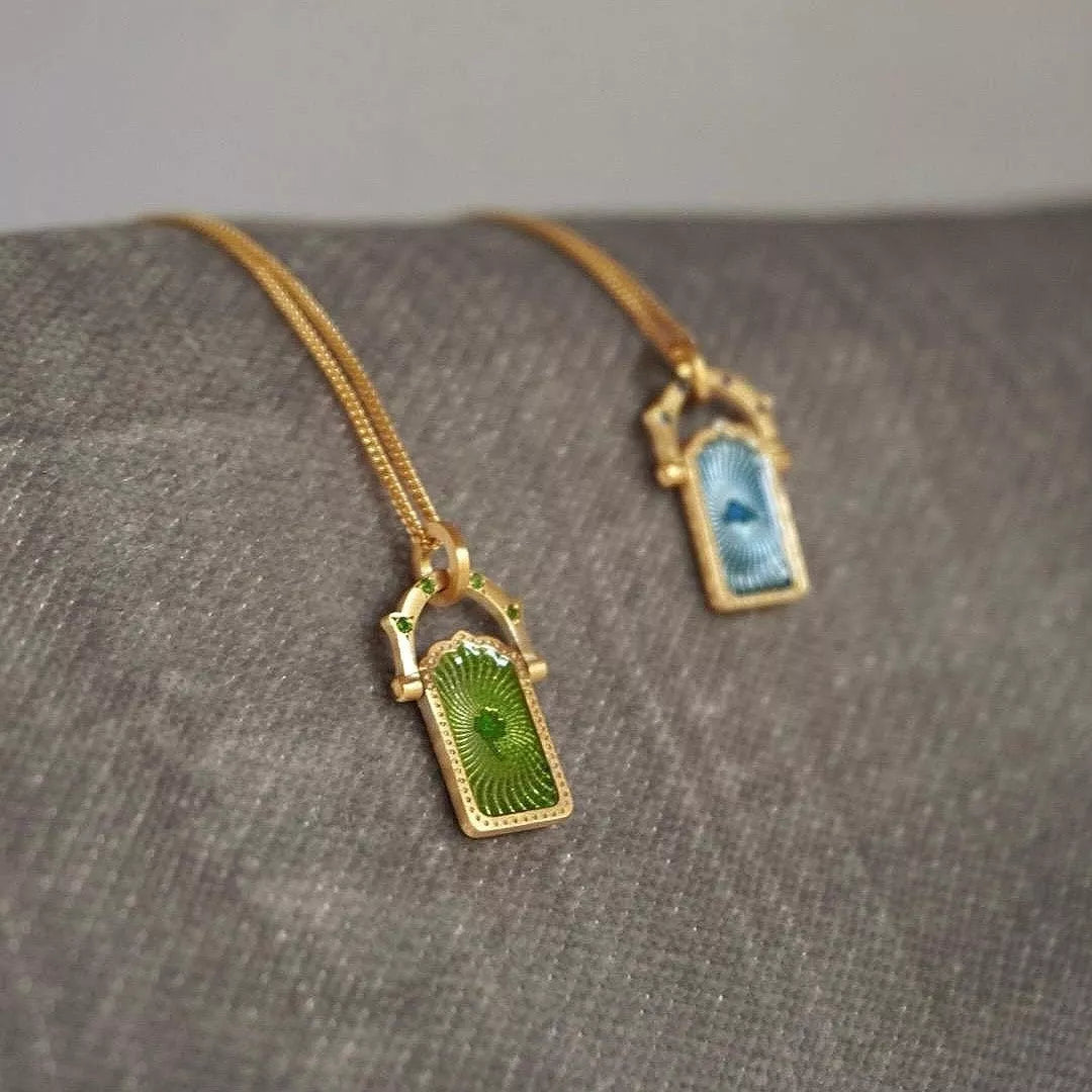 Lucky Charms Pendant Necklace with blue cloud charm on gold-plated chain and green clover charm on gold-plated chain