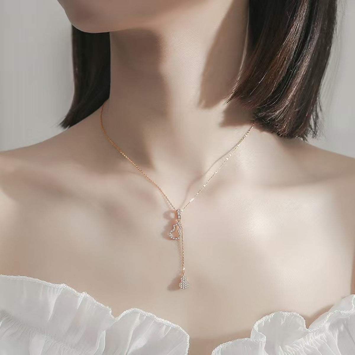 Rose gold necklace with zircon gourd-shaped pendant and drop charm