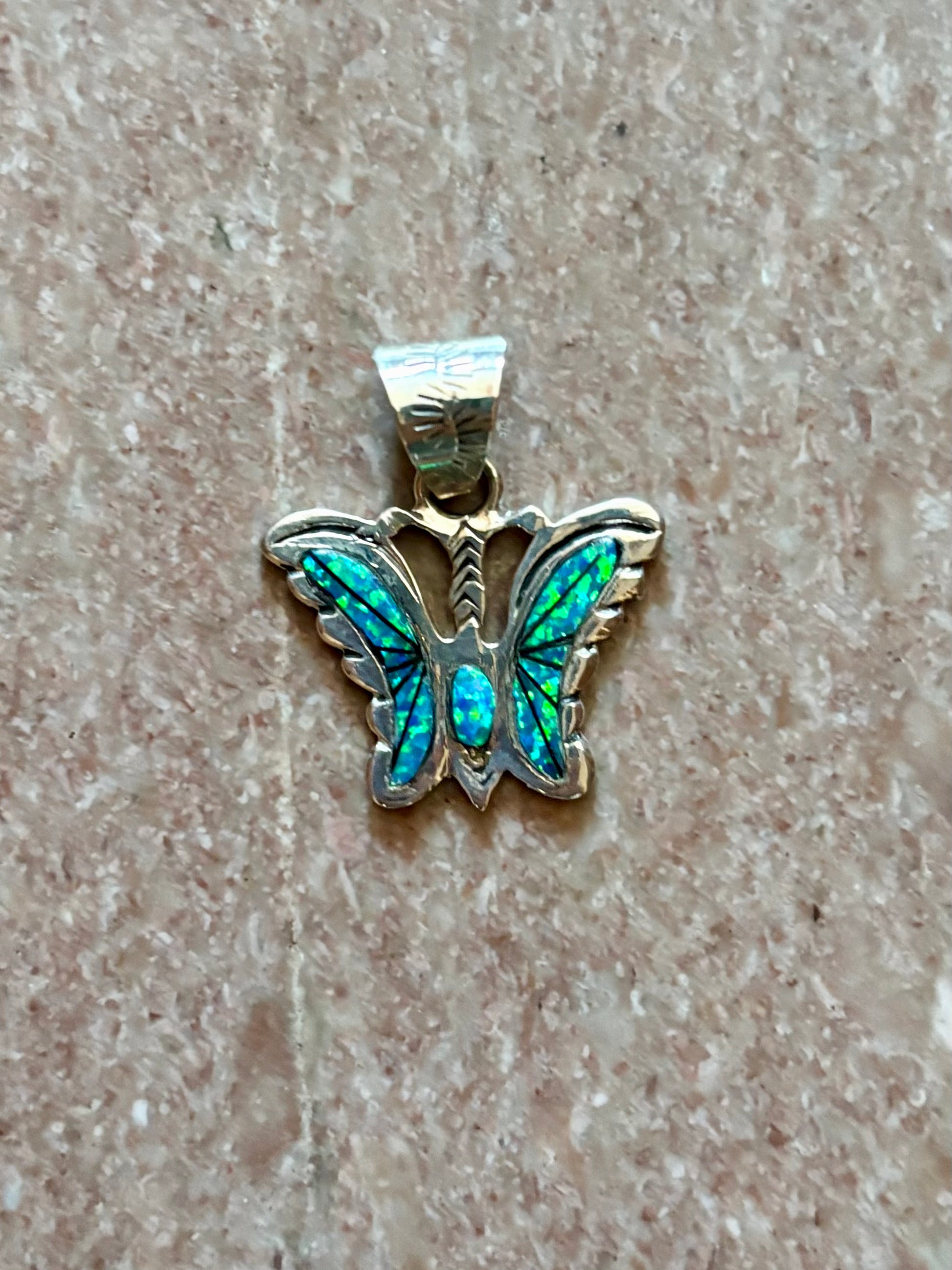 Sterling silver opal butterfly pendant with blue-green opal inlay from the Enchanted Crystals Collection.