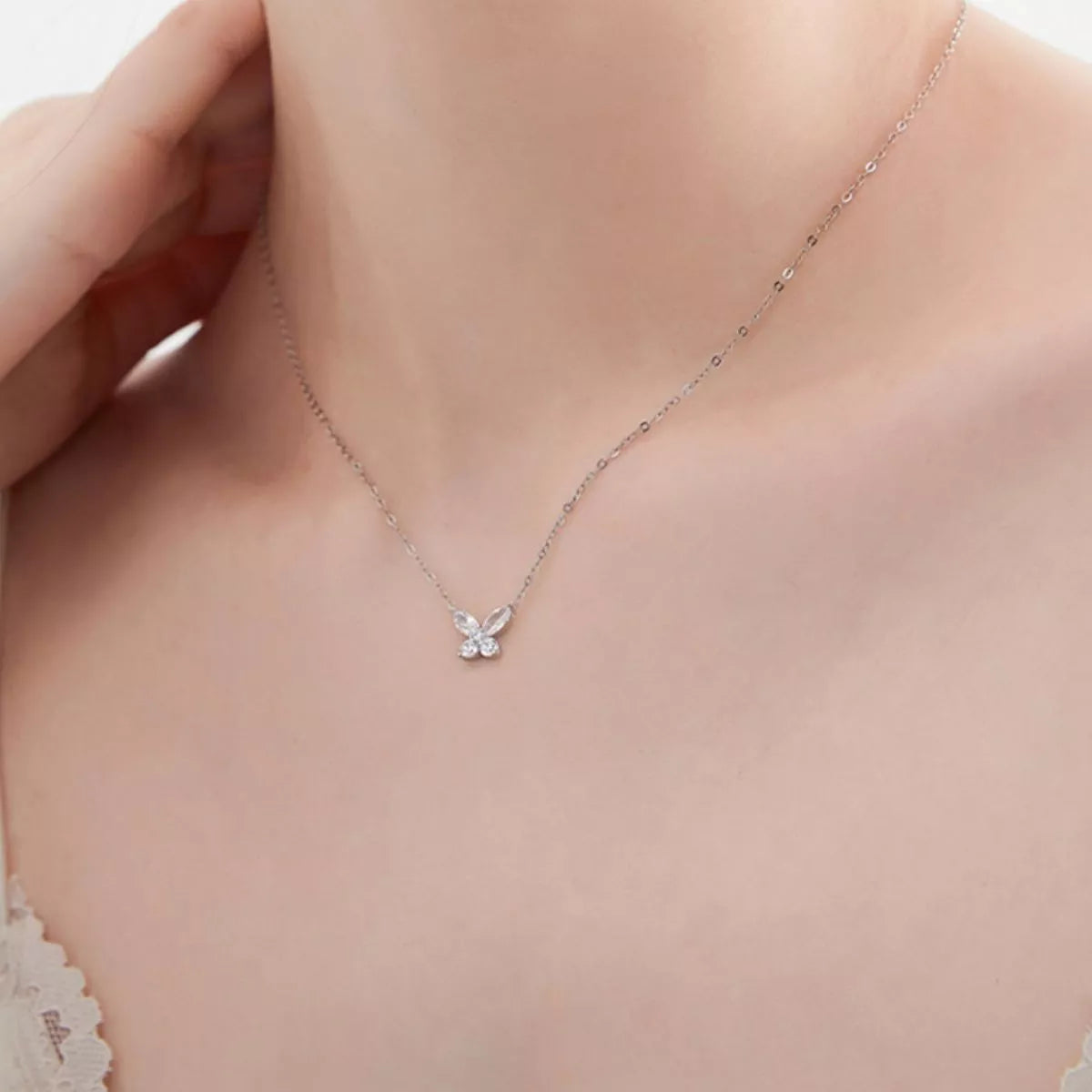 Butterfly-shaped moissanite pendant necklace in platinum-plated sterling silver.
