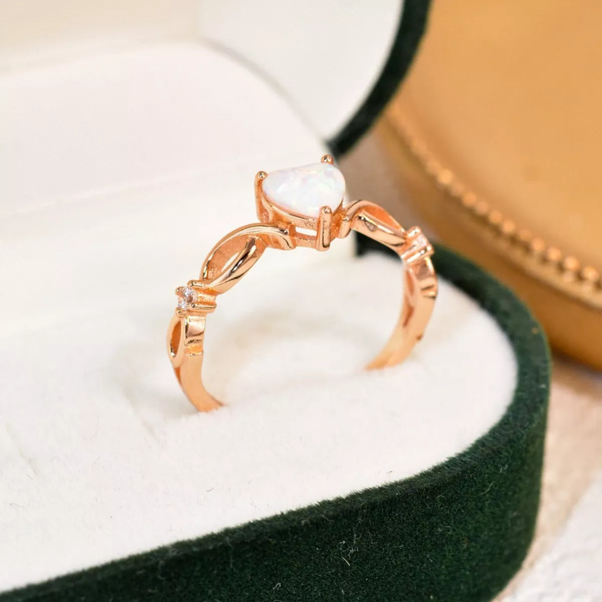 Heart-shaped opal ring with twist band and zircon accents in sterling silver.