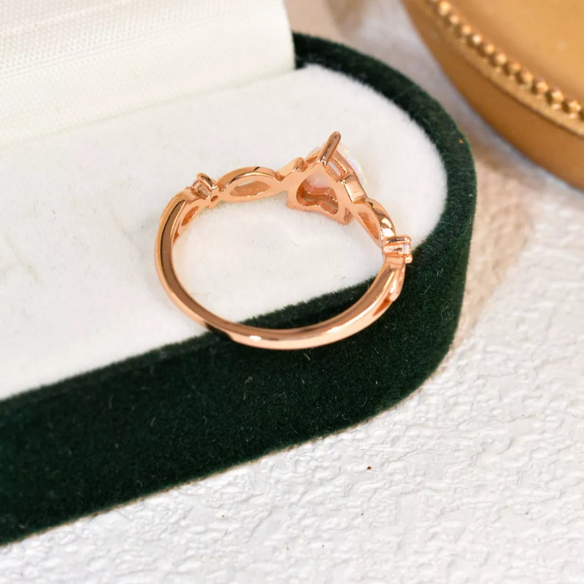 Heart-shaped opal ring with twist band and zircon accents in sterling silver.