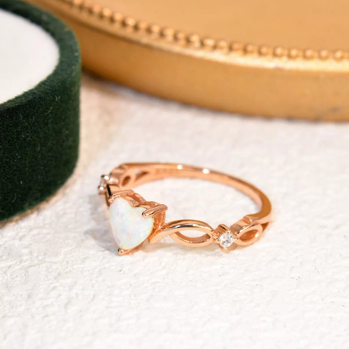 Heart-shaped opal ring with twist band and zircon accents in sterling silver.