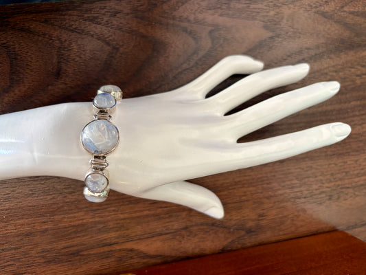 Sterling silver moonstone bracelet with multiple round moonstones and a toggle clasp, shown on wrist and display hand