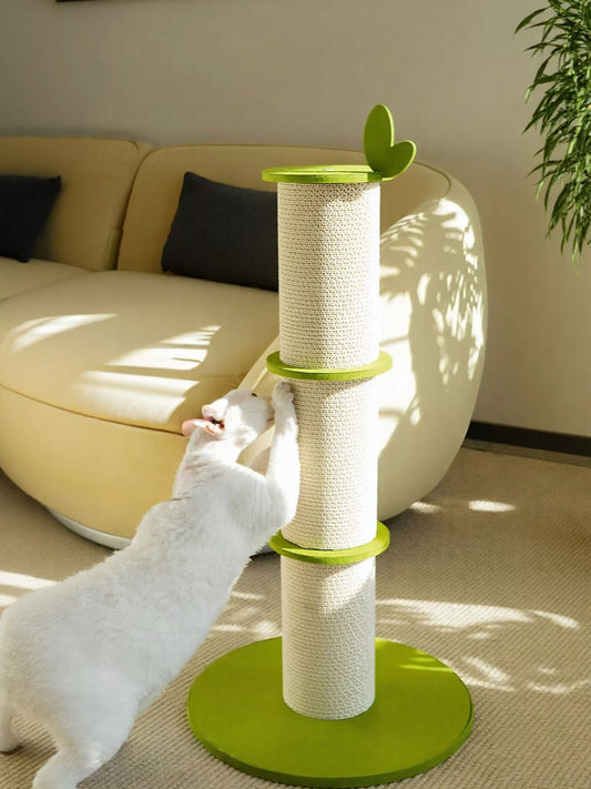 White cat stretching on modern green linen scratching tower with leaf accent