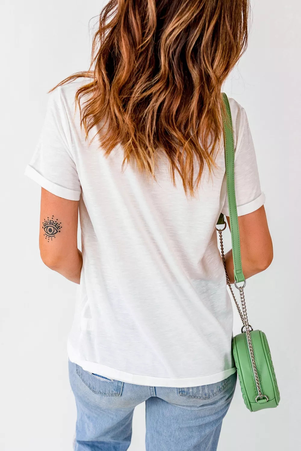 White short sleeve graphic tee with a painterly mallard duck design over muted green stripes, styled with camo shorts.