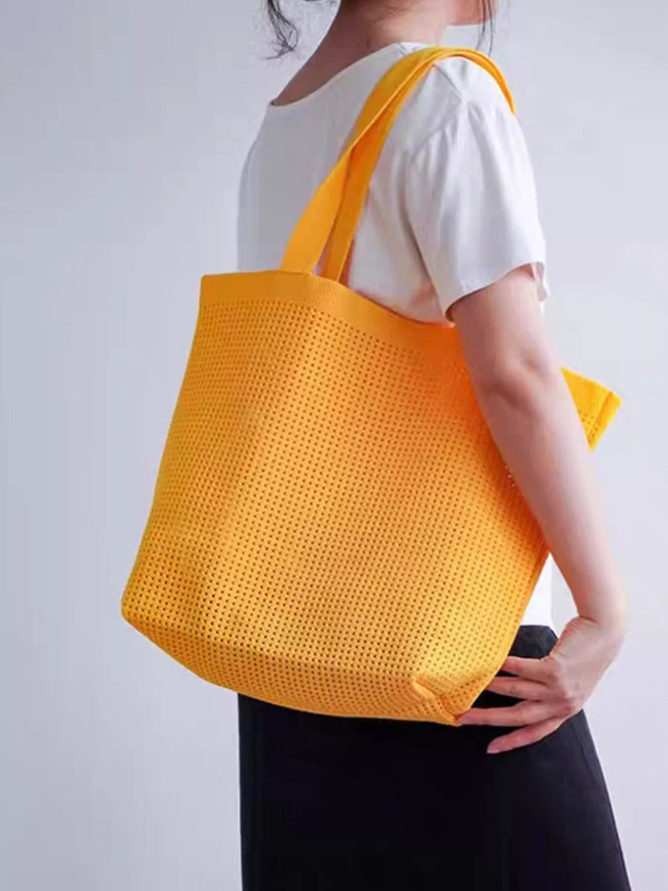 Large mesh shoulder tote bag made from lightweight polyester, perfect for beach days, markets, travel, and everyday errands.