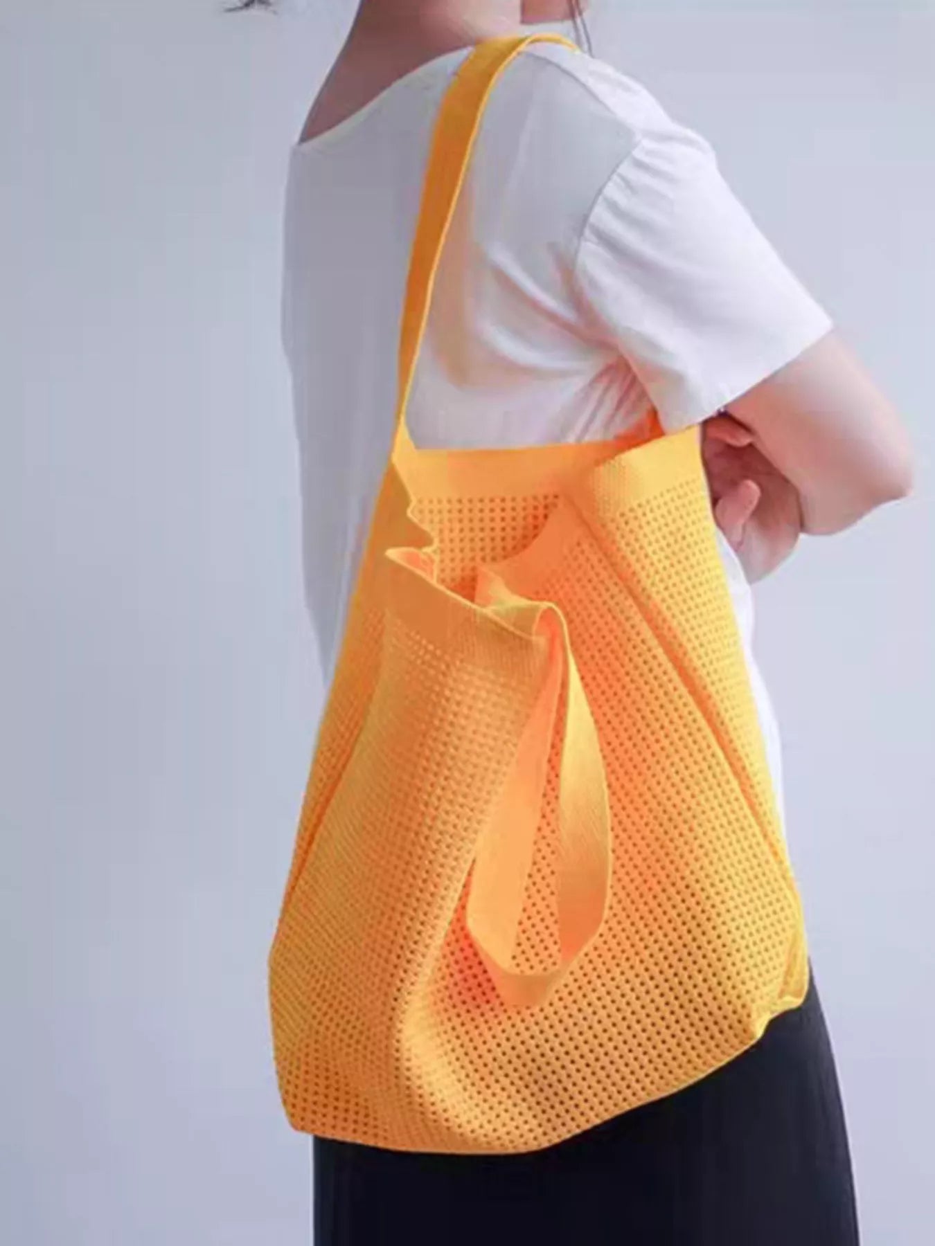 Large mesh shoulder tote bag made from lightweight polyester, perfect for beach days, markets, travel, and everyday errands.