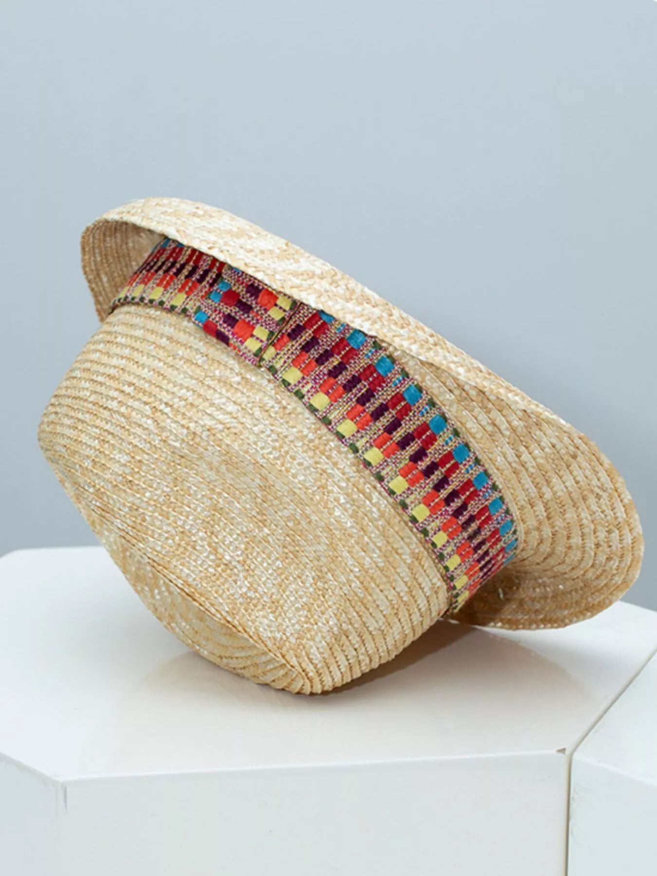 woven straw hat with colorful boho band detail and classic brimmed shape