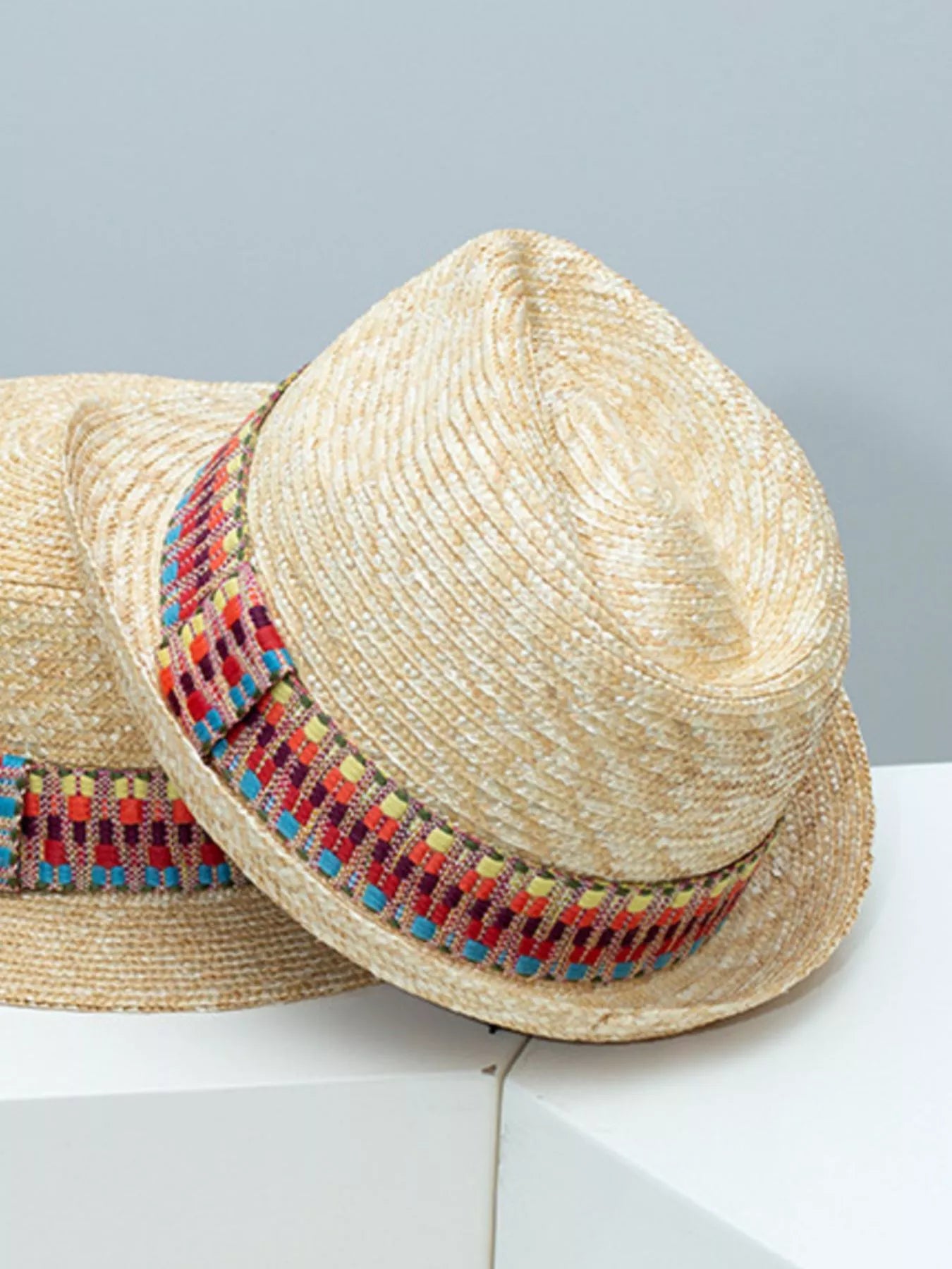 woven straw hat with colorful boho band detail and classic brimmed shape