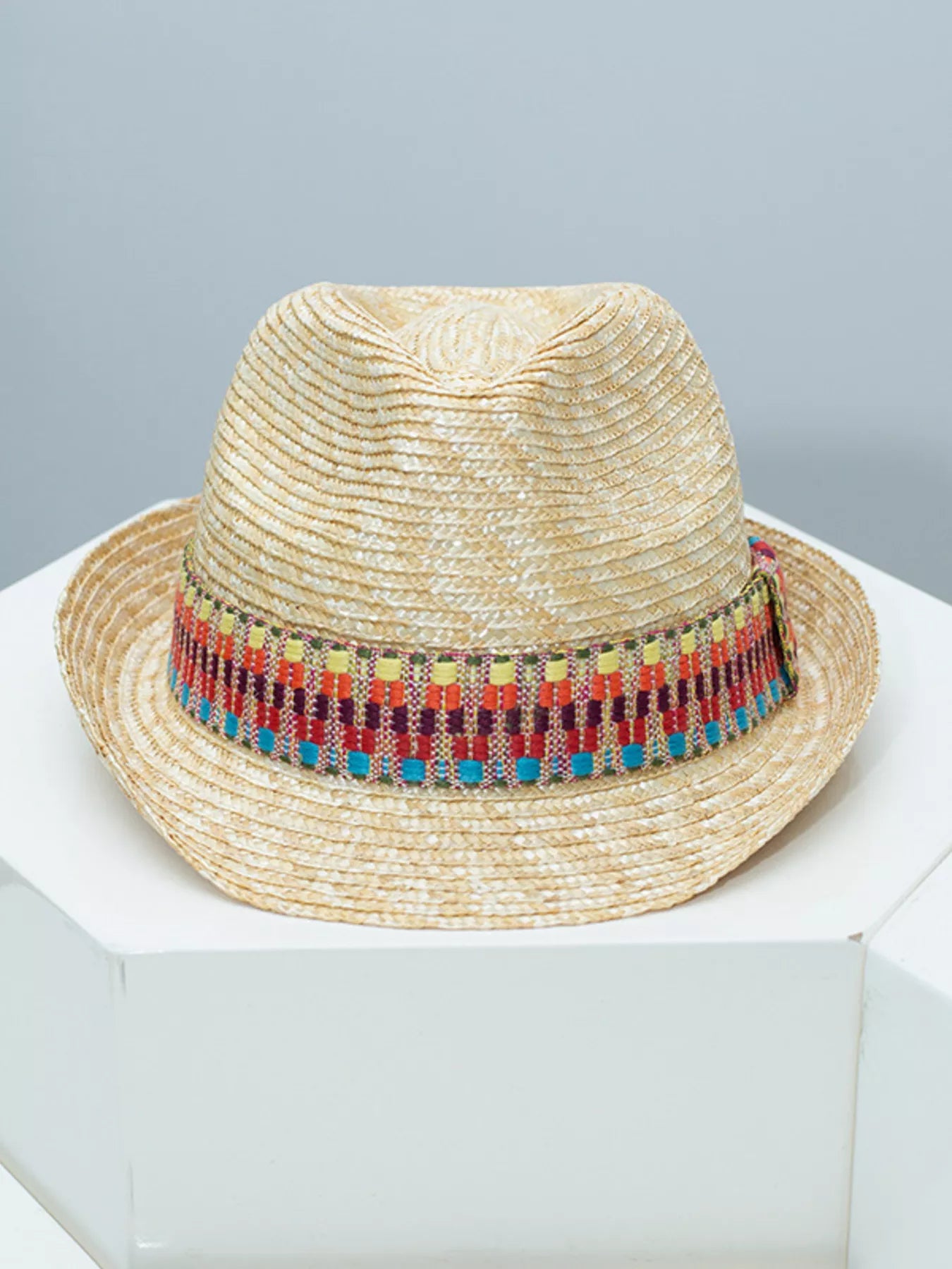 woven straw hat with colorful boho band detail and classic brimmed shape