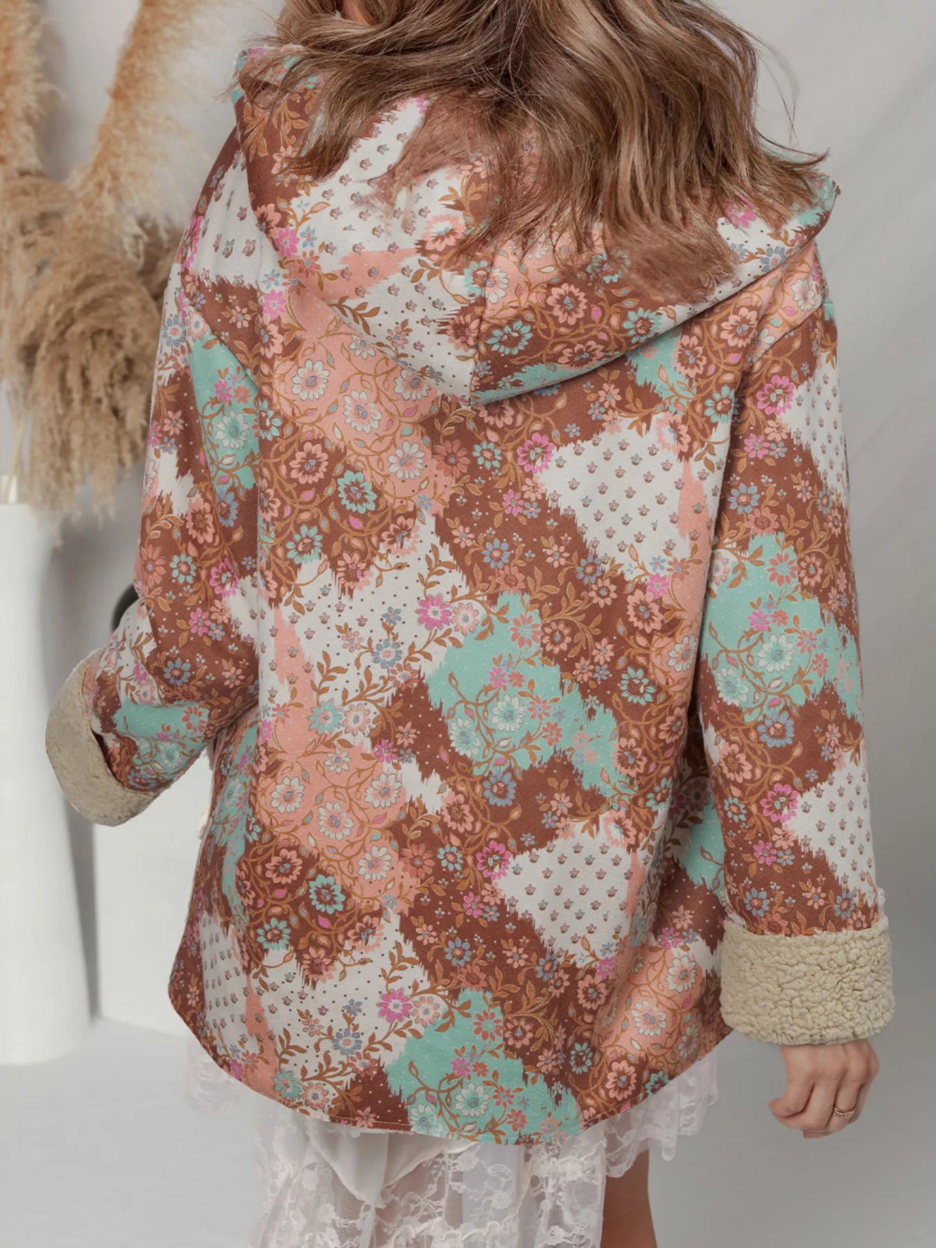 Meadow Bloom Sherpa Jacket – oversized floral printed hooded coat with sherpa lining and front pockets.