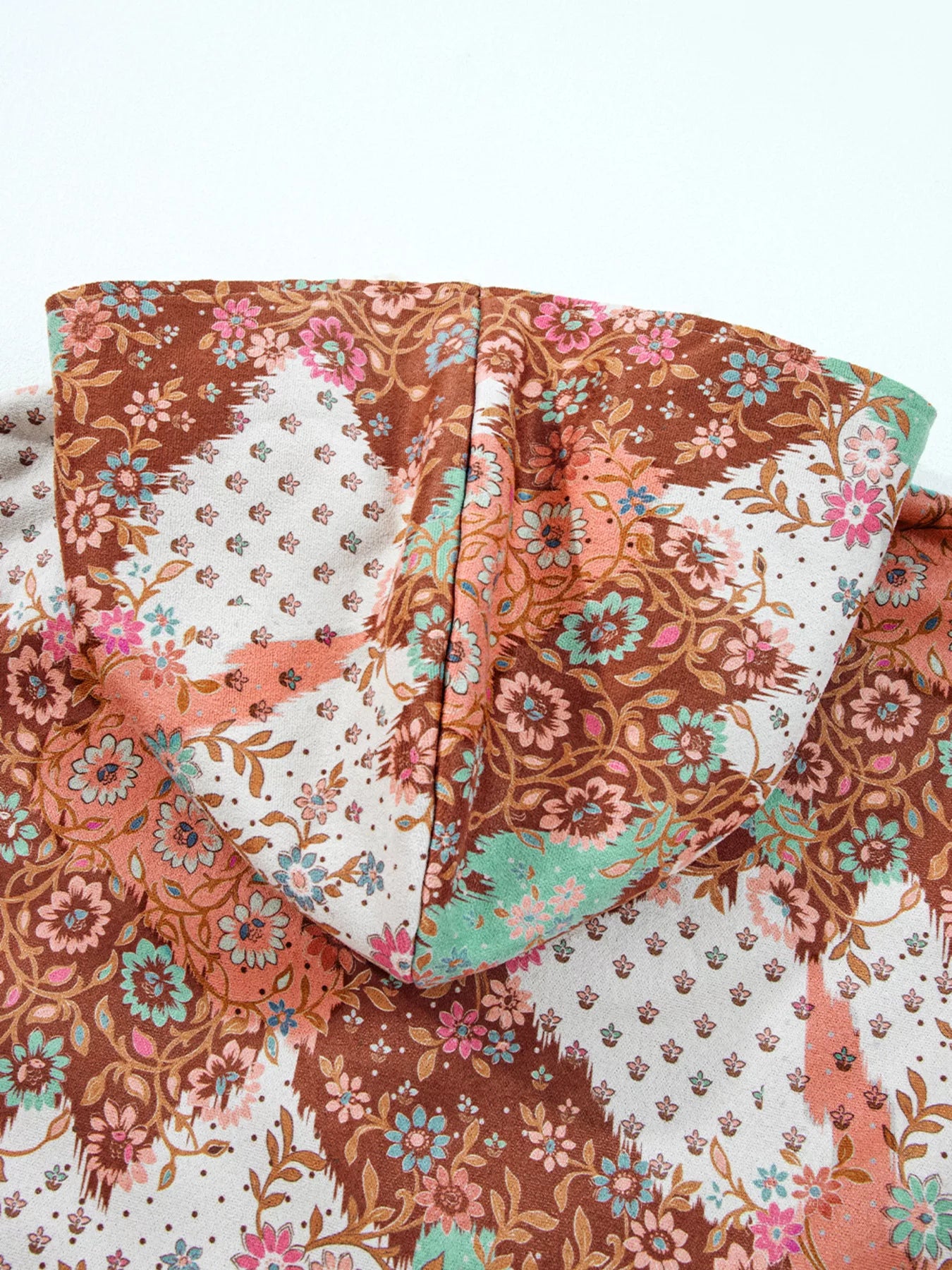 Meadow Bloom Sherpa Jacket – oversized floral printed hooded coat with sherpa lining and front pockets.