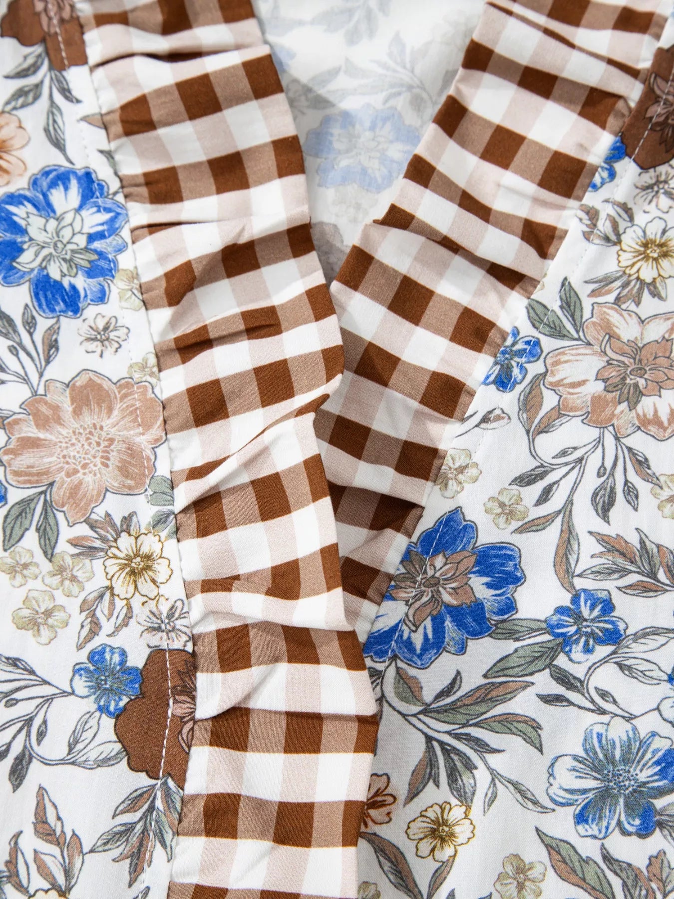 Floral blouse with gingham ruffle V-neckline and frilled sleeves styled with blue jeans