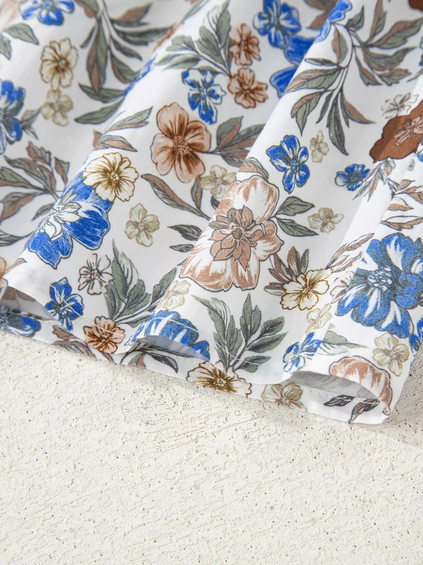 Floral blouse with gingham ruffle V-neckline and frilled sleeves styled with blue jeans