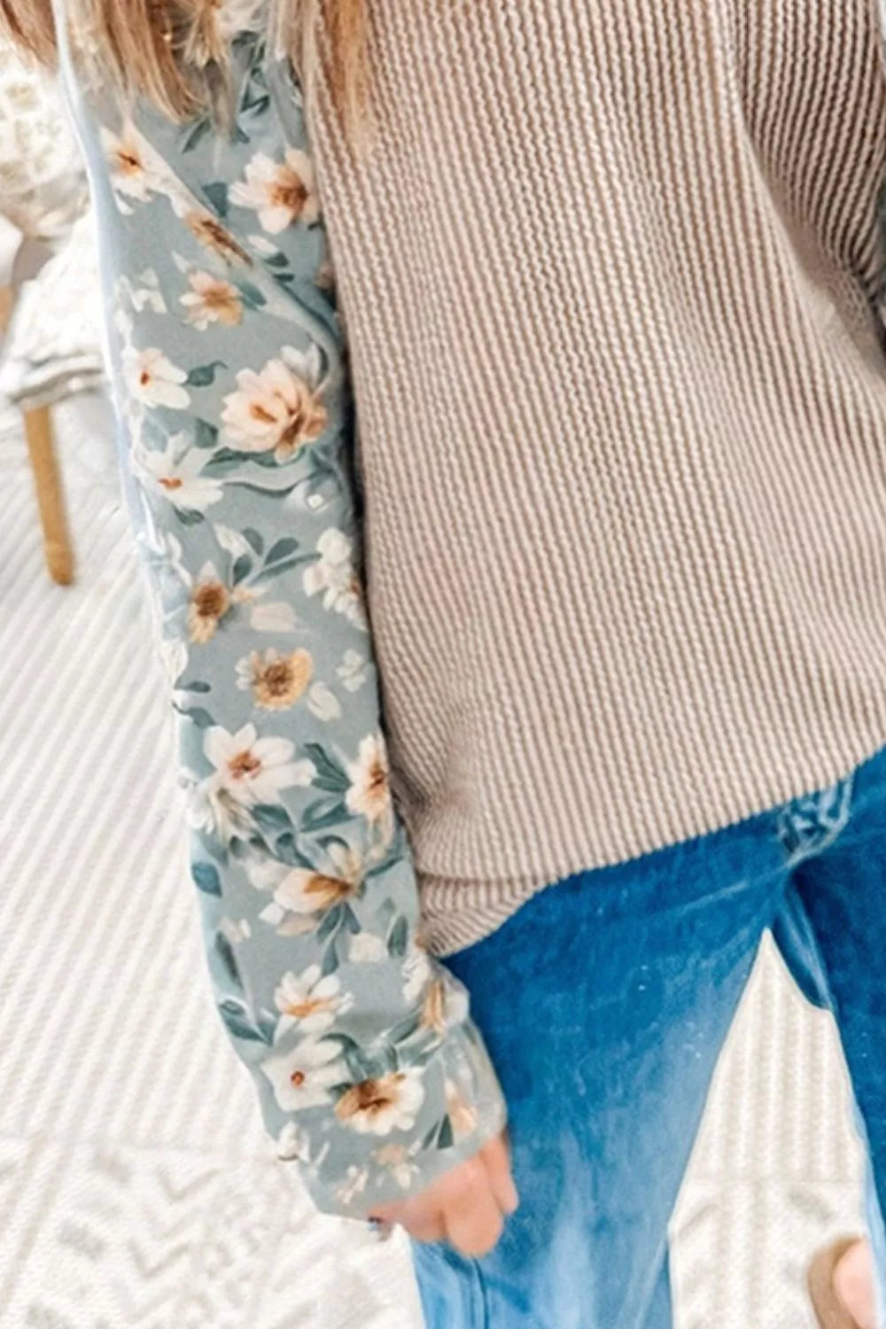Ribbed knit top with floral long sleeves styled casually with jeans for everyday wear