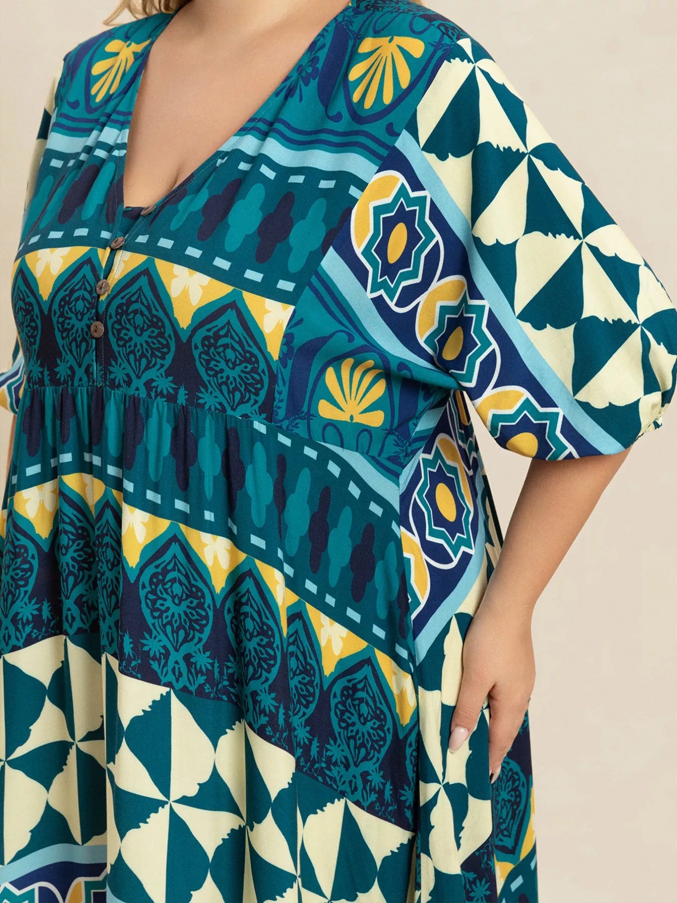 Plus size Mediterranean print midi dress in teal, turquoise, and yellow with buttoned V-neckline and flowy fit