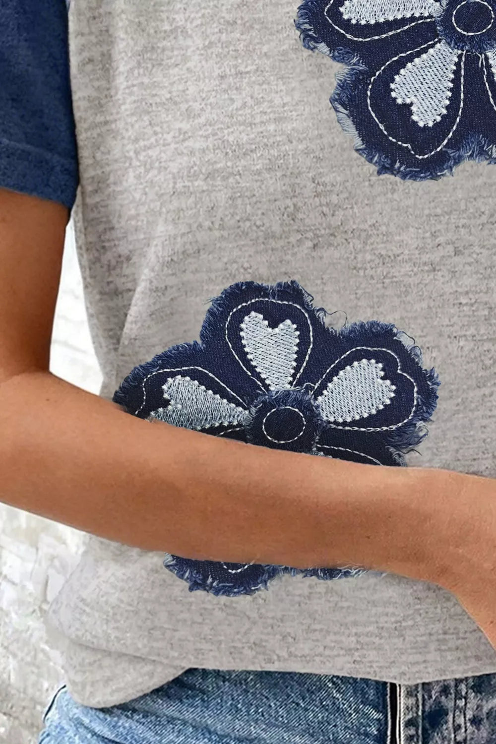heather gray raglan t-shirt with oversized distressed navy daisy floral appliqué and blue sleeves