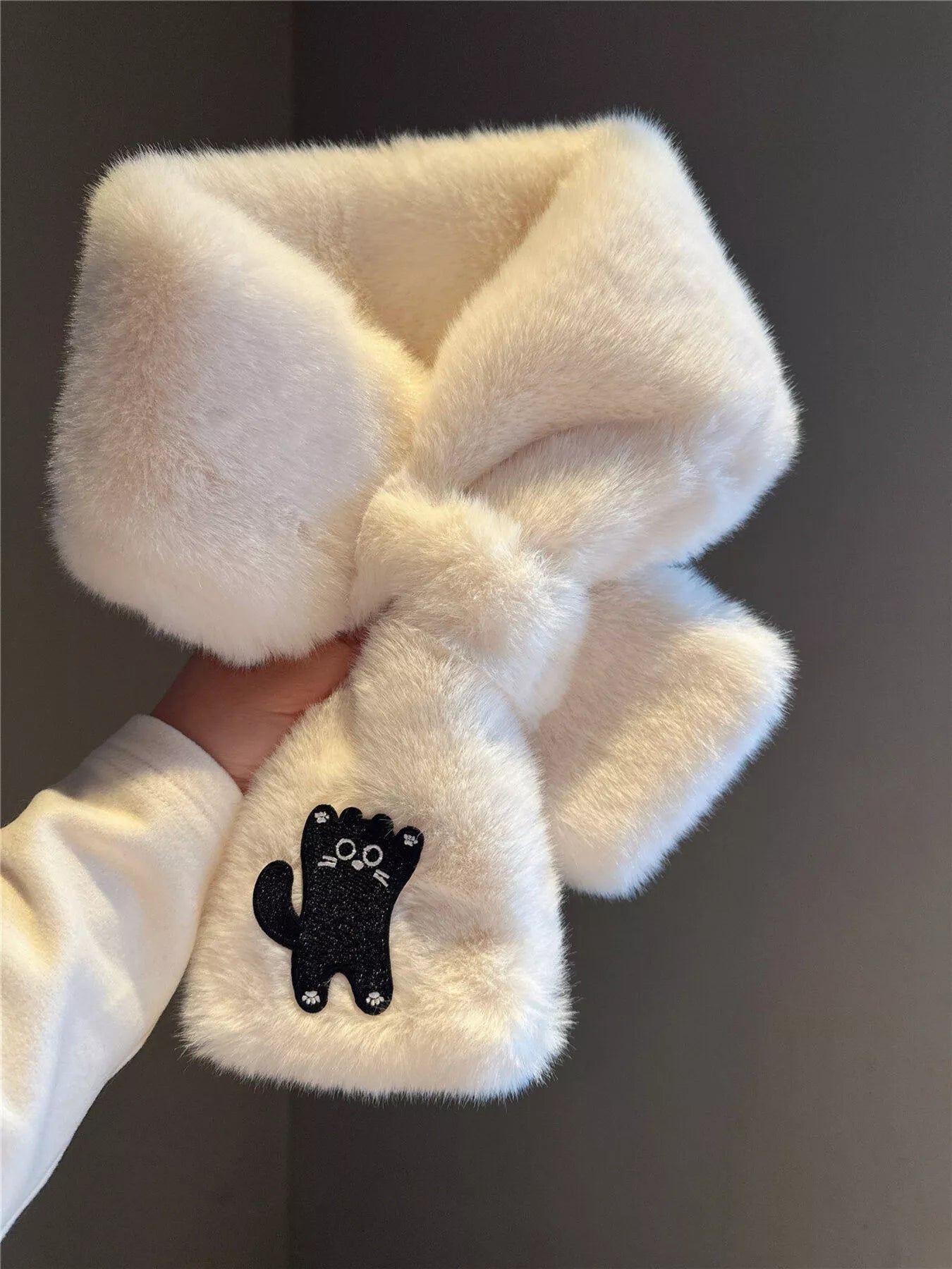 Cream plush scarf with a black kitty patch, soft and cozy winter accessory
