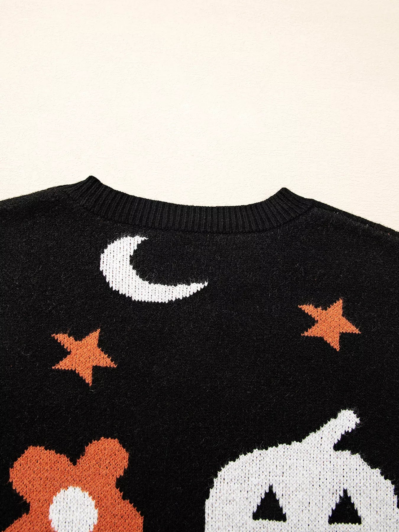 Black Halloween sweater with jack-o’-lanterns, moons, stars, and flowers – Midnight Magic style from A Whimsical Affair.