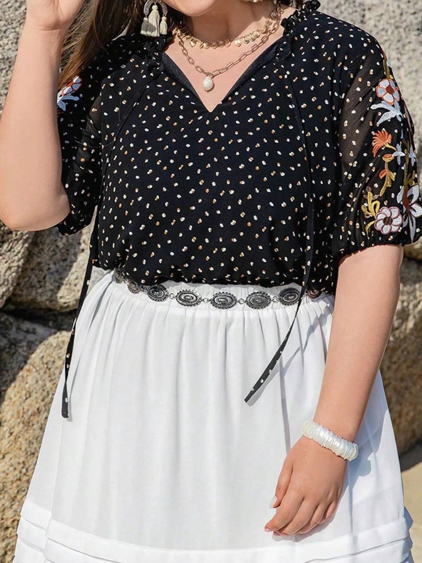 Plus size black embroidered tie top with floral sleeves and polka dot pattern – boho chic blouse for casual or dressy outfits.