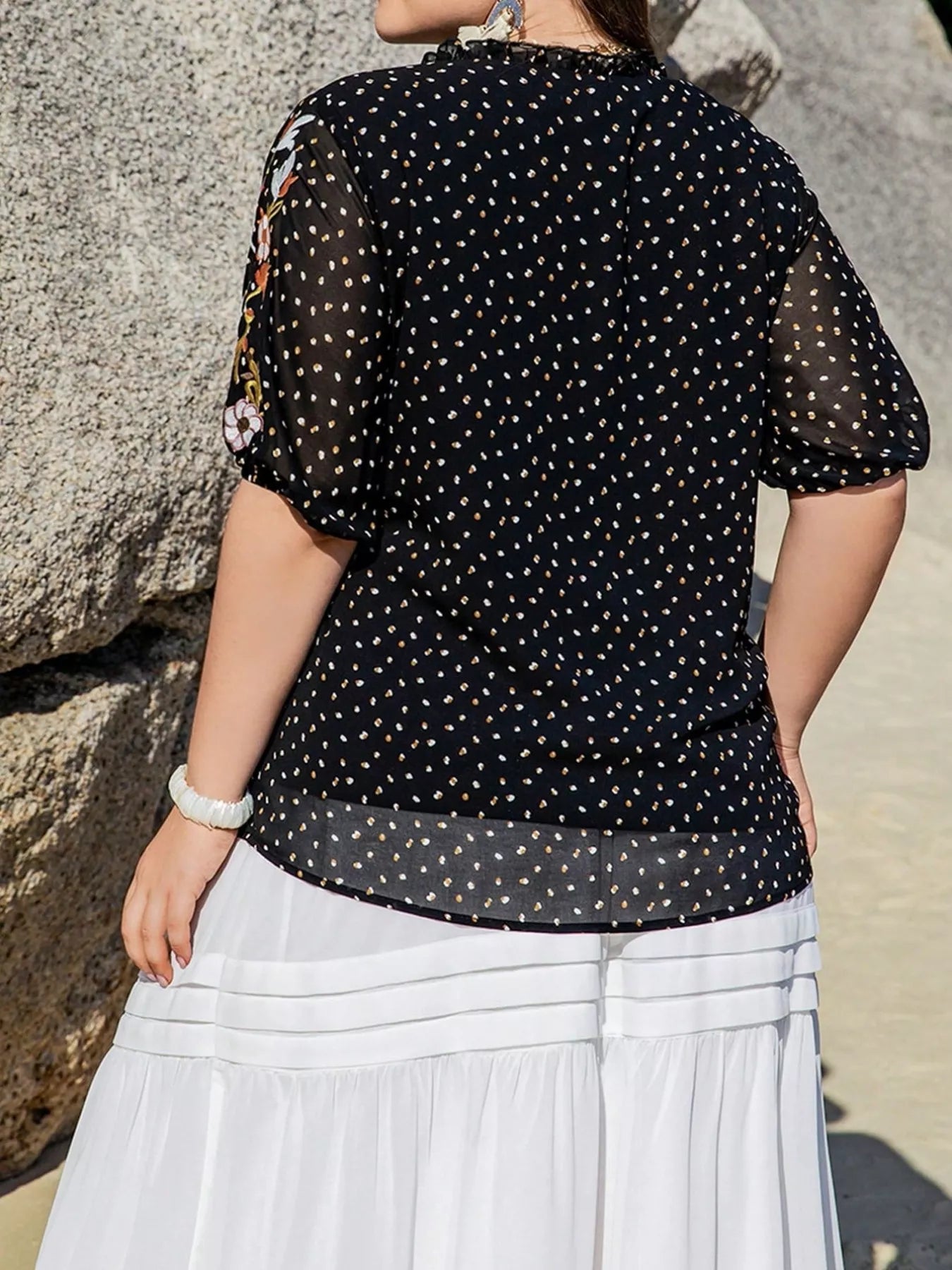 Plus size black embroidered tie top with floral sleeves and polka dot pattern – boho chic blouse for casual or dressy outfits.