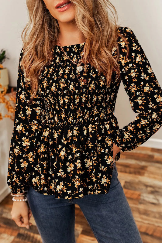 Black floral smocked long sleeve blouse with peplum hem