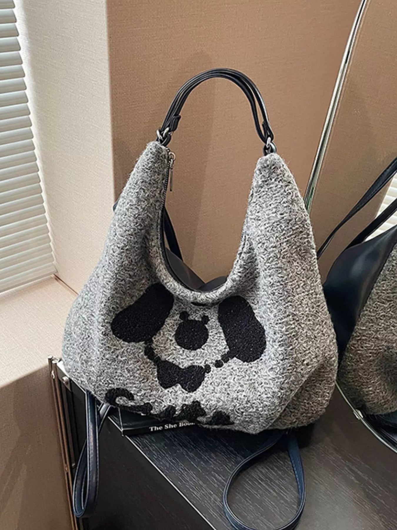 Gray oversized slouch shoulder bag with a soft textured fabric and playful puppy face design