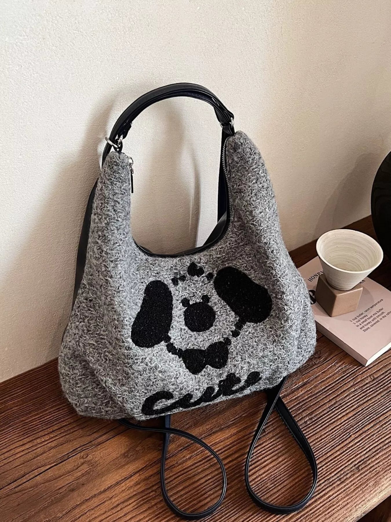 Gray oversized slouch shoulder bag with a soft textured fabric and playful puppy face design