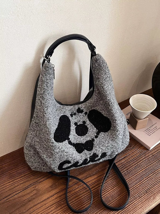 Gray oversized slouch shoulder bag with a soft textured fabric and playful puppy face design
